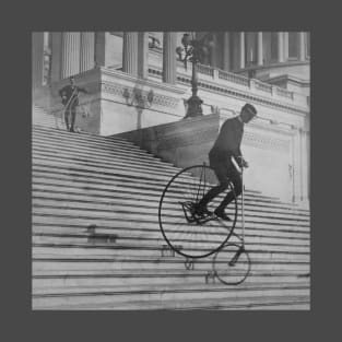 "A Perilous Ride" (black and white) - man rides penny farthing bicycle down Capitol steps in Washington DC, 1884 - vintage photo, cleaned and restored T-Shirt