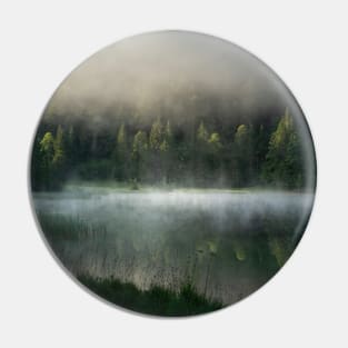 Magic Misty Lake. Amazing shot of a wooden house in the Ferchensee lake in Bavaria, Germany, in front of a mountain belonging to the Alps. Scenic foggy morning scenery at sunrise. Pin