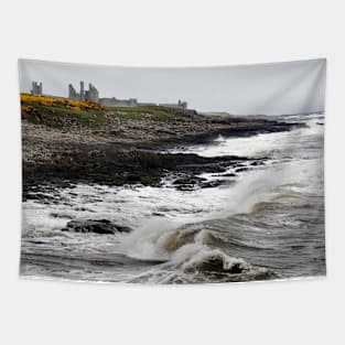 Dunstanburgh castle with rough waves battering the coast in Northumberland, UK Tapestry