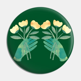 Green hands with yellow flowers on green background Pin