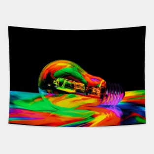 Illuminated light bulb reflecting colors against black background Tapestry