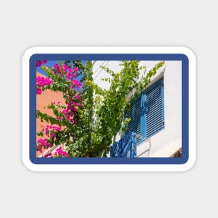 Pink bougainvillea climber and blue shutters in Greece. Magnet