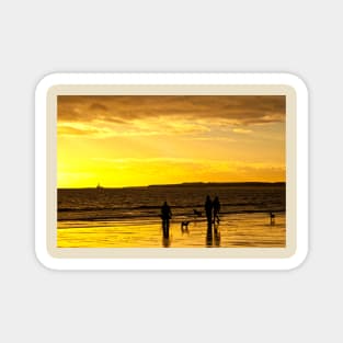 Dog walkers on the beach at sunrise Magnet