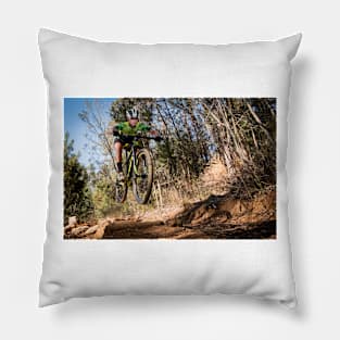 Mountain biker getting air on a single track Pillow