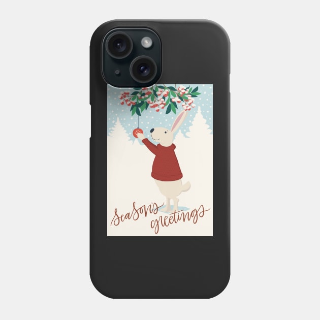 Cute rabbit in red sweater hanging up Christmas decorations in a snowy winter landscape Phone Case by marina63