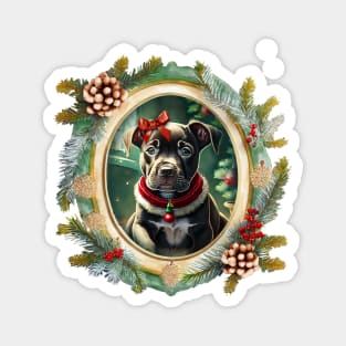 A cute black puppy dog wearing a festive bow and dog collar, in a winter Christmas picture frame with pinecones and winter berries Magnet