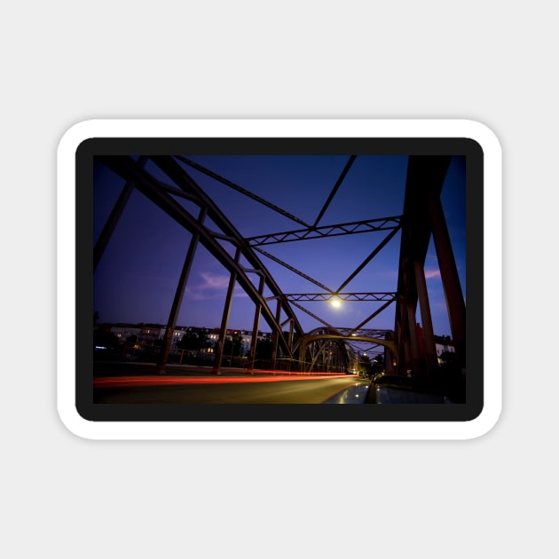 Perspective of an iron bridge with car light trails at twilight in Berlin, Germany Magnet by Reinvention