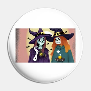Two skeletons wearing witch hats and holding a candle Pin
