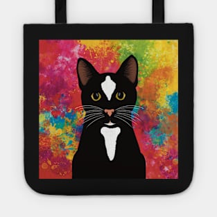 The cute and alert black and white tuxedo cat is waiting and watching you , colorful  background Tote