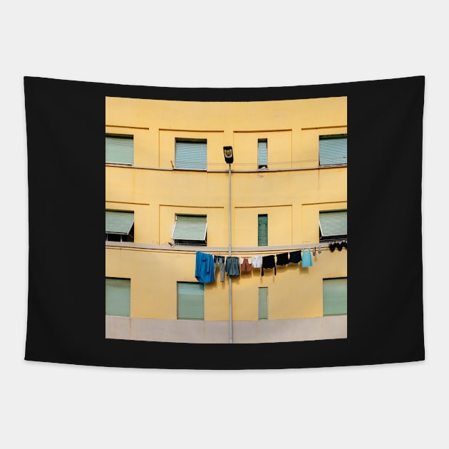 Laundry Drying on Washing Line Against Yellow Building Facade in Italy Tapestry by visualspectrum