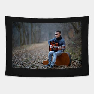 Guitarist singing outdoor in the forest Tapestry