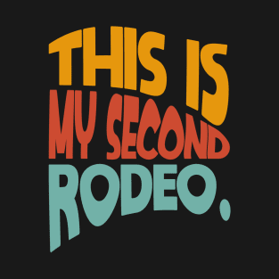 "This is my second rodeo." in plain white letters - cos you're not the noob, but barely T-Shirt