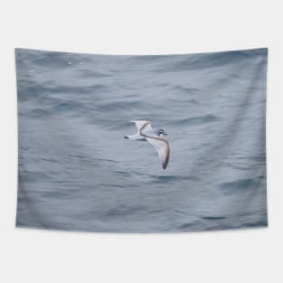 LITTLE BLUE BIRD FLYING OVER BIG BLUE OCEAN Tapestry