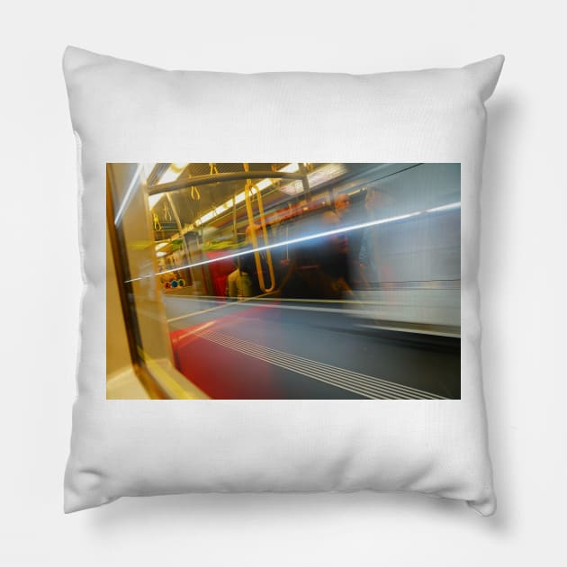 Commuters or passengers blurred in motion through window of passing train Pillow by brians101