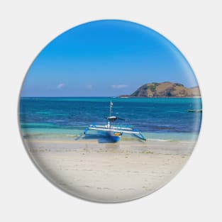 A paradise lagoon beach with a blue longtail boat Pin