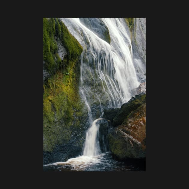 A beautiful waterfall cascades down a mountain in Ireland. by karinelizabeth