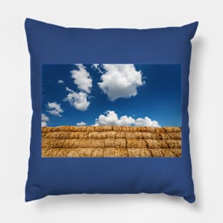 Bales of straw under blue cloudy sky Pillow