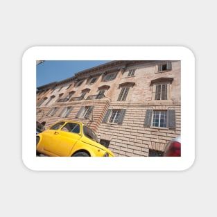 Bright yellow classic Fiat 500 in Italian street. Magnet