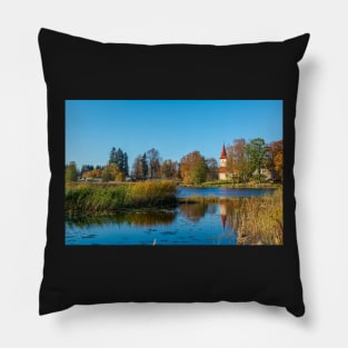 Church standing on the calm lake shore in sunny day Pillow