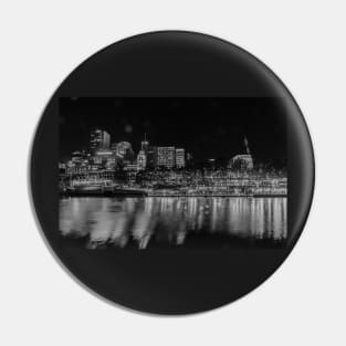 City at night, buildings, lights and corporate brands neon signs across Yarra River in monochrome Pin