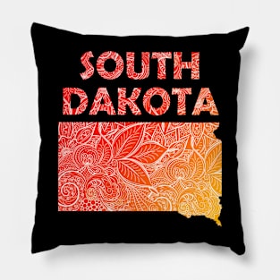 Colorful mandala art map of South Dakota with text in red and orange Pillow