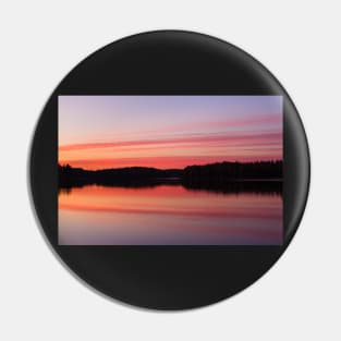 Serene view of calm lake and tree silhouettes Pin