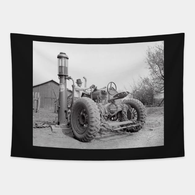 Filling the Tractor, 1940. Vintage Photo Tapestry by historyphoto