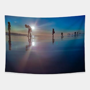 Copy of Silhouetted people in a row on a sand beach. Tapestry