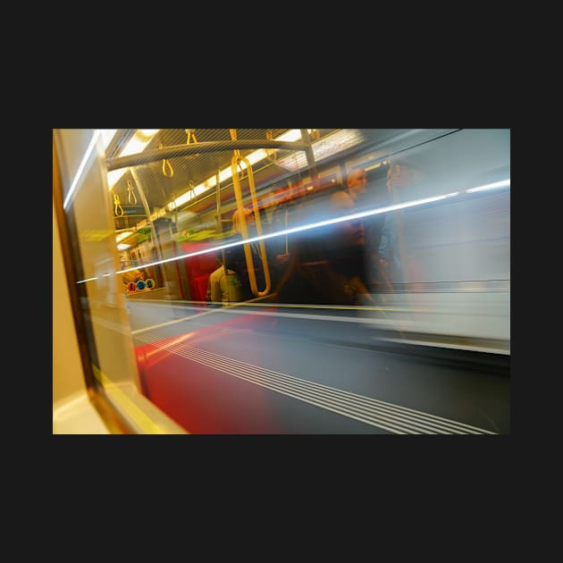 Commuters or passengers blurred in motion through window of passing train by brians101