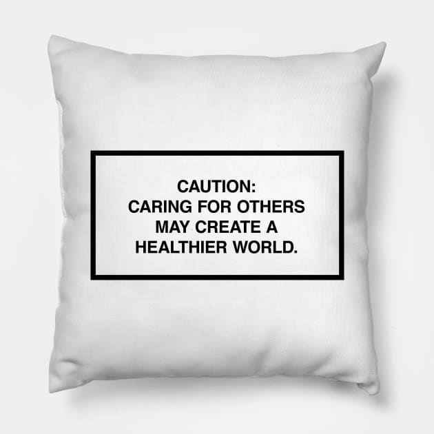 Caution: Caring for others may create a healthier world. Pillow by lumographica