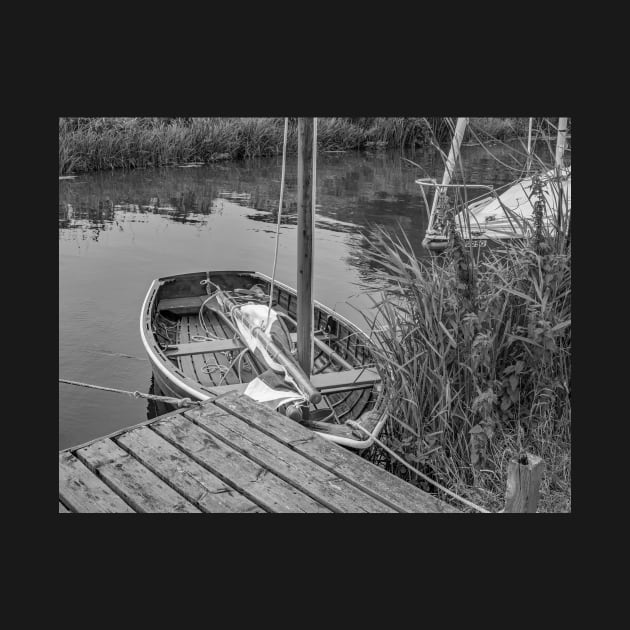 Small wooden boat moored to a quay heading on the Norfolk Broads by yackers1