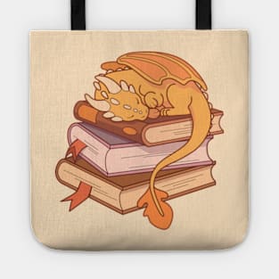 Little golden dragon sleeping on a stack of books Tote