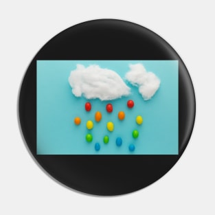 Photo illustration depicting clouds and rainbow-colored raindrops Pin