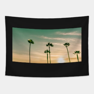 Retro image sun setting on horizon through tropical palms. Tapestry