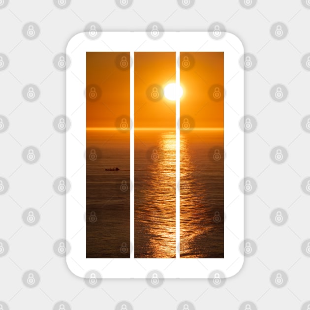 Wonderful landscapes in Norway. Nord-Norge. Beautiful scenery of a midnight sun sunset at Nordkapp (Cape North). Boat and globe on a cliff. Rippled sea and clear orange sky. (vertical) Magnet by fabbroni-art