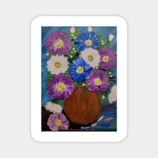 A lovely boutique of flowers in a blue vase . Magnet