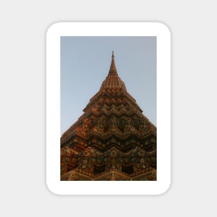 First low angle view of a Buddha stupa reaching symmetrical in the clear sky. Magnet