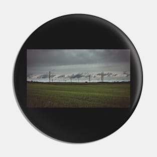 Moody sky over meadow and power lines Pin