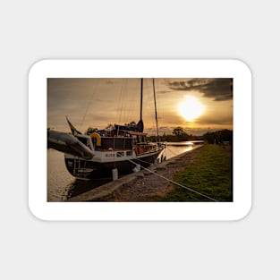 at sunset an old sailboat at the dock in Söderköping, Göta Canal in Sweden Magnet