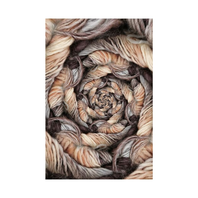 beige and brown skein of wool on a plain black background by mister-john