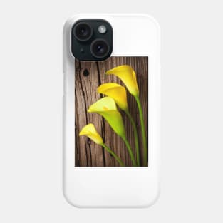 Calla lilies against wooden wall Phone Case