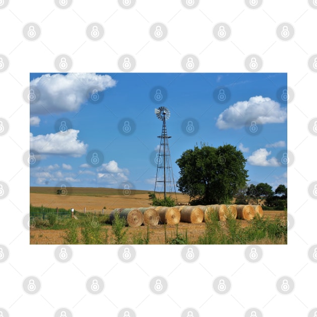 Kansas Windmill with Hay Bales and sky. by ROBERTDBROZEK