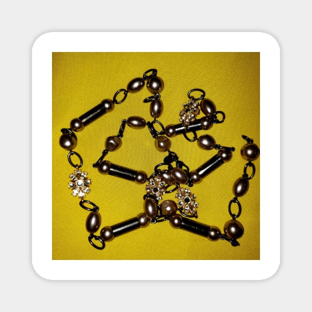 Pearls, black beads, and chains, on a deep yellow background Magnet by Kim-Pratt