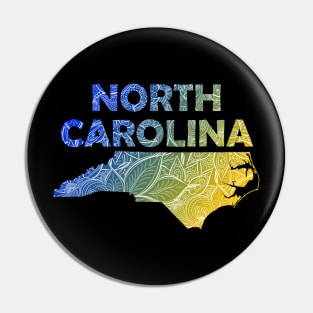 Colorful mandala art map of North Carolina with text in blue and yellow Pin