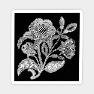 embroidery image with fabric and threads forming a stylized black and white flower branch Magnet