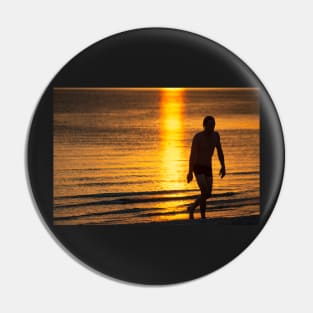 Silhouette of man in the golden light at St KIlda Beach, Melbourne. Pin