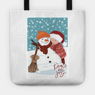 Cute wintery landscape with a Child making a snowman out in the snow Tote