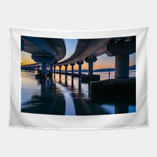 Curving lines and calm water under Tauranga Harbour Bridge at sunrise. Tapestry