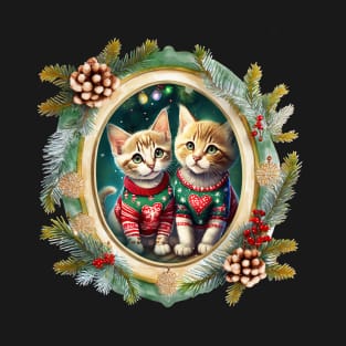 Two cute kittens wearing festive Christmas sweaters with red hearts, in a winter themed picture frame with pinecones and winter berries T-Shirt