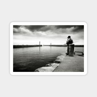 A boy fishing in the harbour at Whitby - Yorkshire, UK Magnet